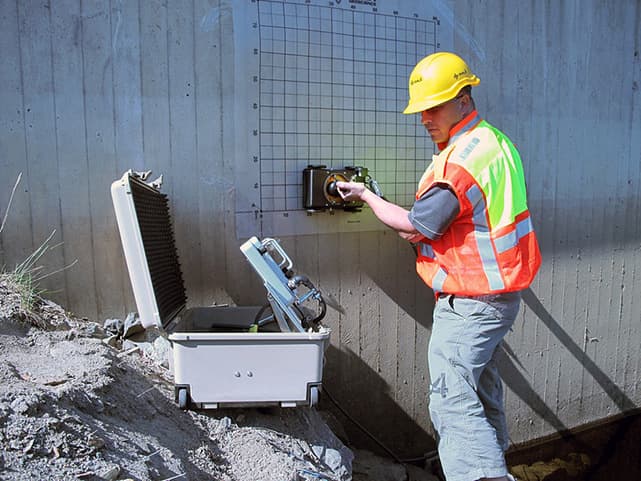Professional technician using GPR concrete scanning equipment at construction site in Dubai