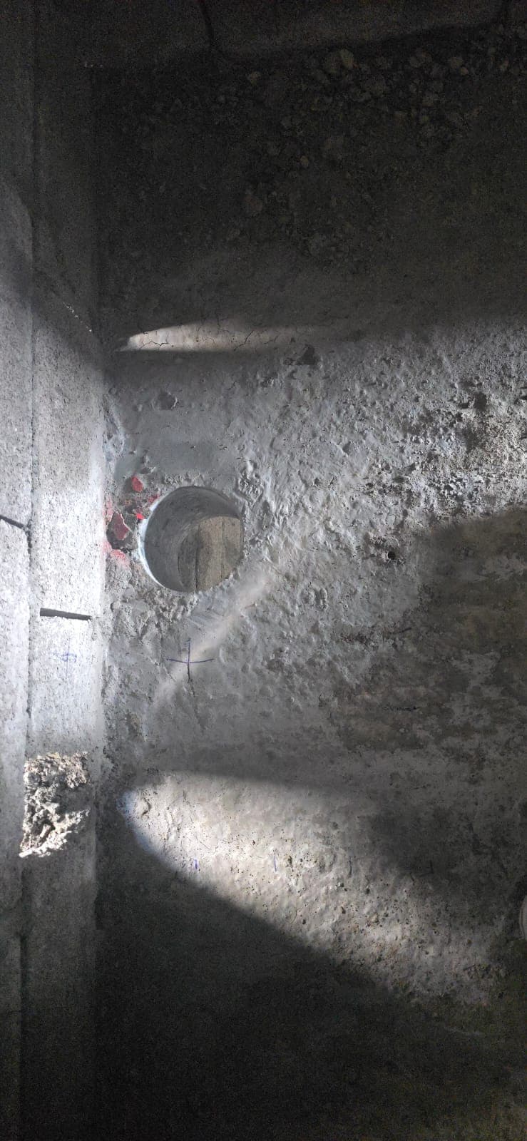 Ground penetrating radar scan markings and core-drilled hole on concrete slab Dubai project